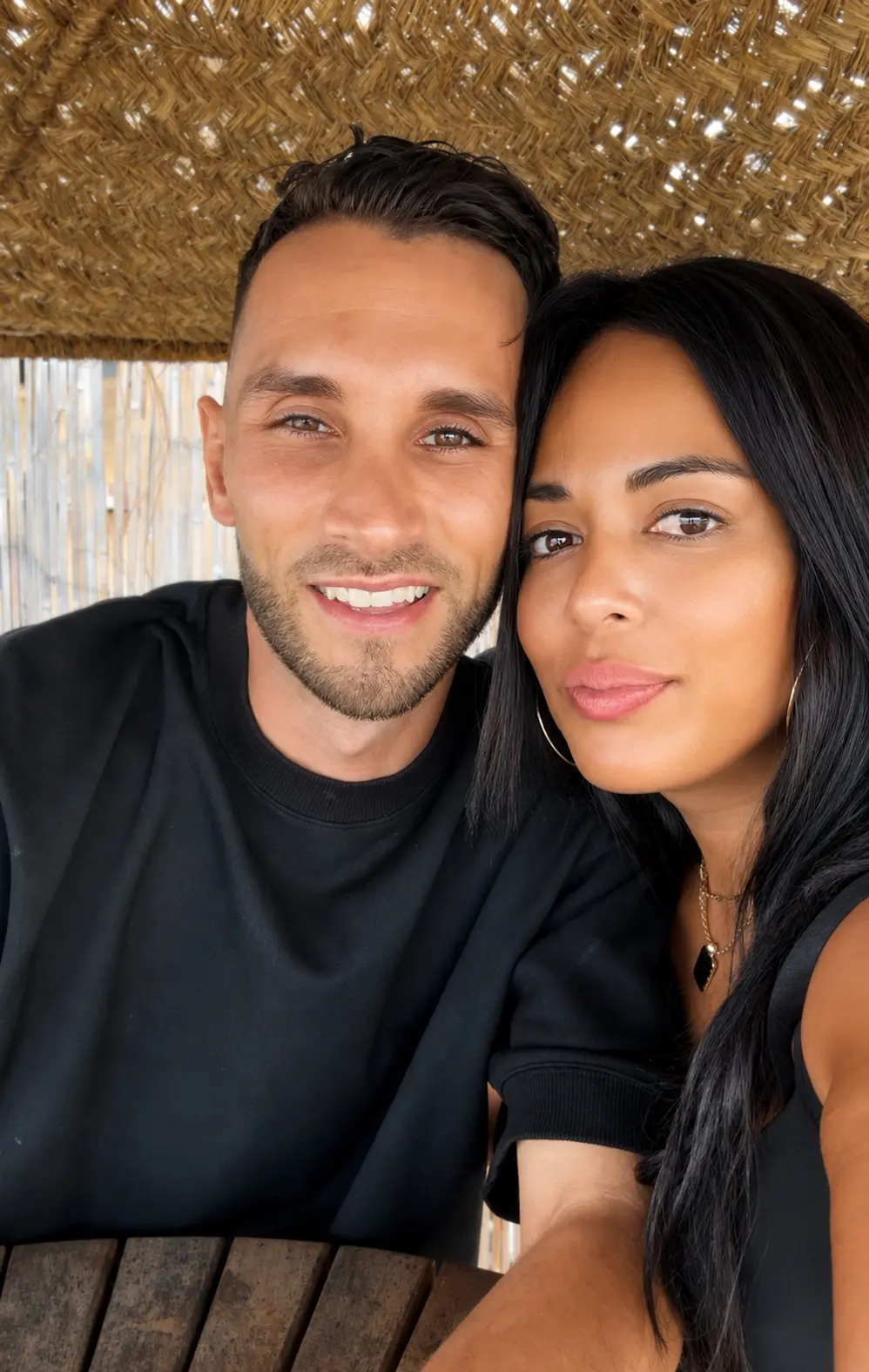 Emmanuelle and Sylvain, founders of Chillz, smiling together under a thatched roof
